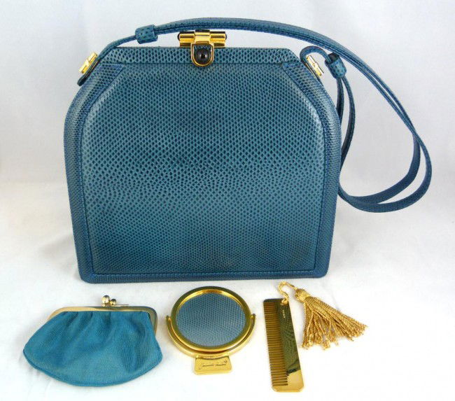 JUDITH LEIBER TEAL GREEN LIZARD SKIN PURSE: Judith Leiber teal green lizard leather purse. Has gold hardware. Teal green silk interior lining. Two pockets to interior. Includes Judith Leiber coin purse, mirror and comb. Measures 7 1/2" height x