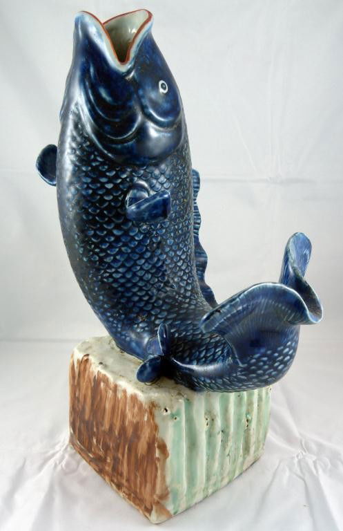 CHINESE PORCELAIN FIGURAL FISH VASE: Depicts a fish jumping out of the water. The fish's mouth is pointed up and is open to be used as a vase if wanted. No apparent signature. 19th or early 20th century. Measures 14" height (35.5cm).