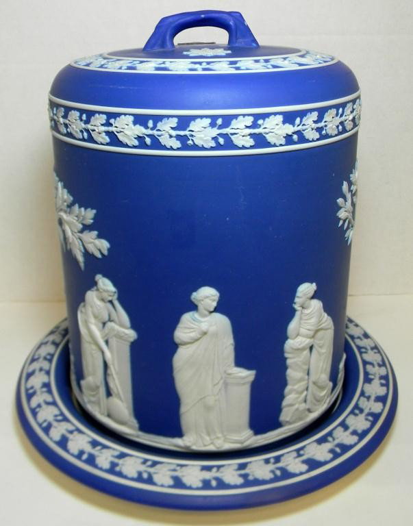 WEDGWOOD BLUE JASPERWARE LARGE CHEESE STILTON: Wedgwood blue Jasperware cheese stilton. Depicts women playing instruments and singing. Makers mark to bottom. 19th century. Measures 12" height x 12" diameter(30.5cm x 30.5cm).