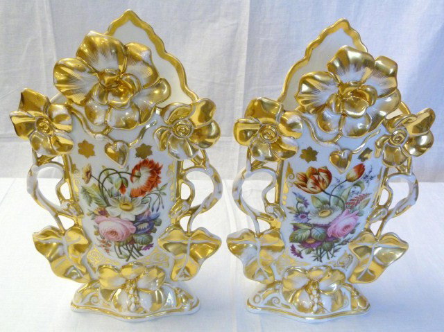 PAIR OF LARGE FRENCH PORCELAIN FLORAL VASES: Each has a beautiful figural gilted floral design. Front has a hand painted depiction of a bouquet. Reverse has a hand painted image of a flower. Has two impressed hatch marks to bottom. Early 20th ce