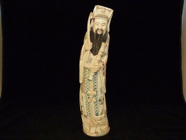 POLYCHROME CHINESE IVORY NOBLEMAN FIGURE SIGNED: Highly detailed ivory figure depicts a nobleman in layered robe with knotted belt. in his left hand he is holding a bamboo stick. In his right hand he is holding a scepter. He has a long black beard.
