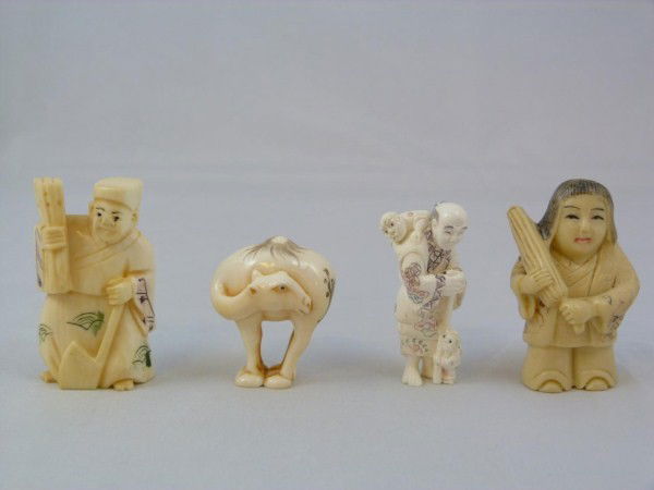 4 POLYCRHOMED IVORY NETSUKE HAND CARVED FIGURES: The first ivory netsuke depicts an old man with walking stick and two children (1 3/4" height, 4.5cm). The next ivory figure depicts a man with an axe and bundle of sticks (2" height, 5.1cm). The next