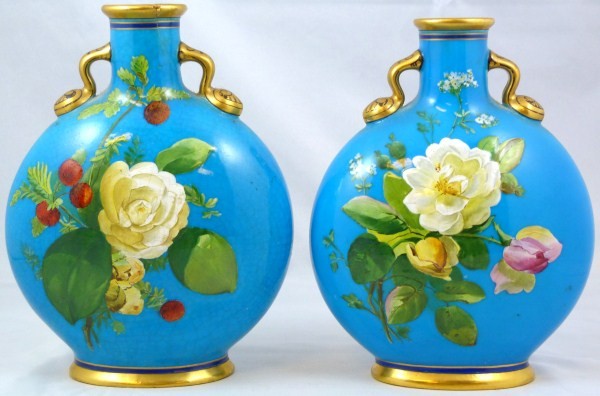 PAIR OF ANTIQUE MINTON JAPONISM FLORAL VASES: Pair of Minton England two handled vases. Both have an enchanting hand painted floral design with a light blue background. Has gilt and cobalt trimming. 19th century. Each measures 7 1/2" height (19cm