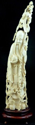 CHINESE IVORY CARVING OF SAU w PEACHES AND BATS: Chinese ivory carving of Sau holding a peach and tall staff. Heavily pierced and reticulated. 14" height + 2" base (35.5cm x 5.1cm).