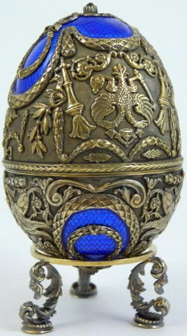FABERGE RUSSIAN SILVER & ENAMEL EGG w STAND: Incredible Russian silver & cobalt enamel egg by Faberge. Has intricate raised design depicting the Russian double headed eagle, torches, wreaths and griffins. Mounted with Cabochon garnets to top and