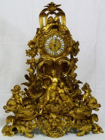 MAGNIFICENT 3pc DORE BRONZE CANDELABRA CLOCK SET: Incredibly detailed large French gilded bronze clock set made by the Raulin company. Of monumental triangular form and elaborate rococo design, the structure made up of numerous castings each piece in