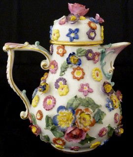 ANTIQUE MEISSEN GERMAN PORCELAIN FLORAL TEAPOT: Beautiful German porcelain covered teapot with figural flower design by the Meissen company. Blue Crossed swords mark to bottom. 19th/20th century. Measures 6" height (15.2cm).