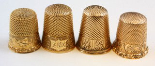 14k YELLOW GOLD THIMBLES - LOT OF 4: Lot of four 14kt yellow gold thimbles. Knurled to top and sides. All have engraved designs to side. Each measures 3/4" to 7/8" (19mm to 22mm) height. Total weight 11.7dwt (18.2g).