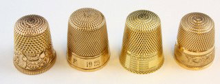 10k YELLOW GOLD THIMBLES - LOT OF 4: Lot of four 10kt yellow gold thimbles. All marked 10K. Knurled to top and sides. All have engraved designs to side. Each measures 3/4" to 7/8" (19mm to 22mm) height. Total weight 10.8dwt (16.7g).