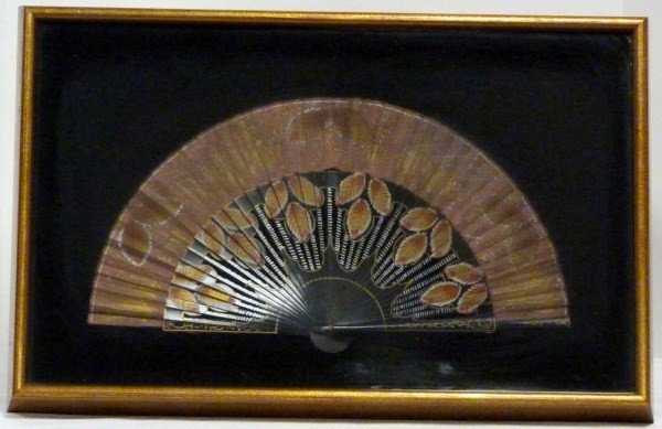 ANTIQUE CHINESE WOODEN FAN IN SHADOW BOX: Has hand painted leaf design throughout. Wood is painted black. Early 20th century. Measures 17" width x 9" height (43.1cm x 22.8cm). Shadowbox measures 22 1/2" width x 14 1/2" height (57.1cm x 36.8cm