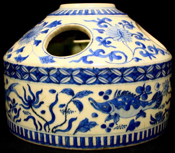 ANTIQUE CHINESE BLUE & WHITE PORCELAIN FLOWER POT: Has hand painted floral design with fish. Has circular opening to top. 3 circular and 1 trapezoidal opening to side. 19th century. Measures 6 1/2" height x 8 3/4" diameter (1.2cm x 19.6cm).