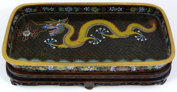 BRONZE & ENAMEL DRAGON & BAT RECTANGULAR TRAY: Tray depicts a dragon with dragon ball with floral bordering. Bottom depicts 6 bats. All on black enamel background. 19th/20th century. Includes fitted wooden base. Measures 7/8" height x 8 1/8" lengt