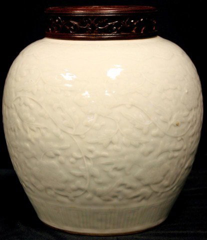 K'ANG HSI CHINESE PORCELAIN VASE w WOODEN SCREEN: Antique Chinese vase with raised floral design. K'ang Hsi period (1662-1722). Has wooden screen cover. Measures 9 3/8" height (23.8cm). Provenance: From the Baerwald collection 1998.