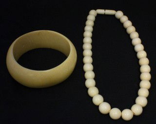 2pc IVORY BANGLE BRACELET & NECKLACE: Single strand ivory necklace with barrel screw closure (not knotted). Beads measure approx 12.5mm. Necklace measures 17" (43cm). Domed ivory bangle bracelet measures 3cm wide (1 1/2") and 3" diameter