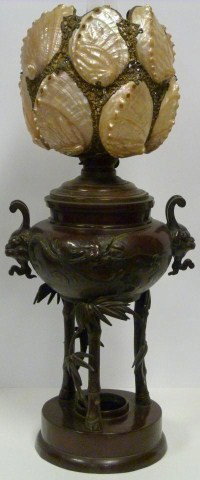 ANTIQUE JAPANESE BRONZE FIGURAL OIL LAMP: Antique bronze Japanese oil lamp with figural dragon design to body and bamboo tree legs. Has abalone shell and bronze shade. 19th century. Measures 33 3/4" height (85.7cm).