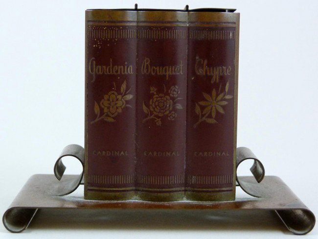 ANTIQUE FRENCH METAL FIGURAL PERFUME BOTTLE HOLDER: Old French metal figural book perfume holder. Holds three fitted bottles, each with label. Early 20th century. Measures 3" height x 3 7/8" length x 2 1/2" depth (7.6cm x 9.8cm x 6.3cm).