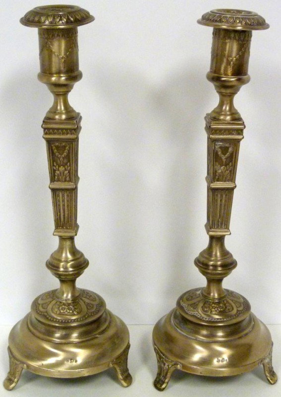 PAIR OF OLD POLISH SILVER CANDLESTICKS: Pair of 800 silver Polish candlesticks. Has 800 silver purity marks and work master marks. Each has a repousse floral design throughout. Made in Warsaw circa 1920. Total weight of candlesticks is 22.2