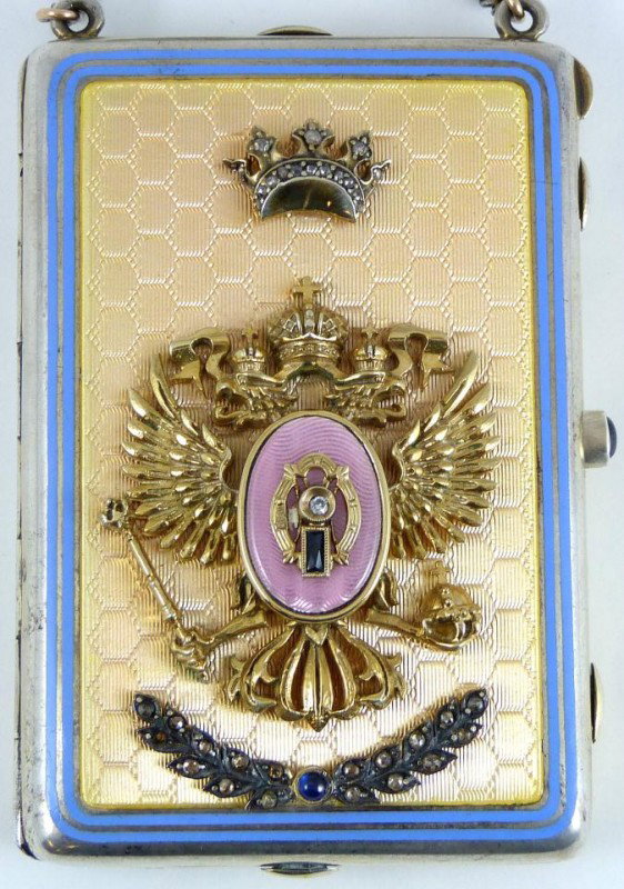 RUSSIAN SILVER GOLD ENAMEL JEWELED CLUTCH COMPACT: Impressive silver & enamel jeweled compact with mounted double eagle and crown design to exterior. Yellow honey comb guilloche design to exterior with blue bordering. Cabochon sapphire set to latch. 3