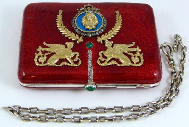 RUSSIAN SILVER GOLD DIAMOND ENAMELED CLUTCH PURSE: Russian silver clutch purse adorned with Griffin and female bust decoration. Also set with many diamonds and has a red enamel guilloche design. Set with cabochon emerald to handle and front. Interior 