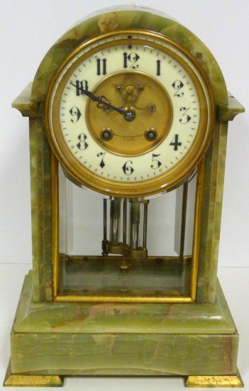 ANTIQUE FRENCH BRONZE & ONYX MANTLE CLOCK: Antique French bronze and green onyx mantle clock. Has white enamel face with black numbers and notches. Has mercury pendulum. Retailed by Merrick Walsh & Phelps Jewelry Company, St. Louis. 19th centu