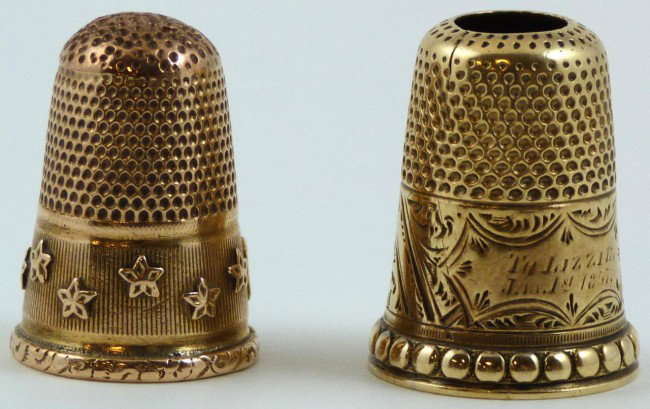 2 ANTIQUE 18K YELLOW GOLD THIMBLES: One has carved lip, offset stars all around with monogram of "TJ". The other has an open bottom, lip has raised beaded border. Wide monogram stating "Tu Lizzie January 1st, 1857". Total weight of 5.7d