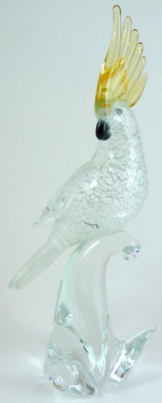 MURANO ART GLASS PERCHED BIRD FIGURE: Murano Italian art glass clear perched bird figure. Has silver flake speckle design to bird and amber glass design to head feathers. Clear base. Measures 12 1/2" height (31.7cm).