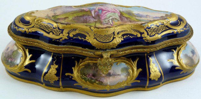 ANTIQUE SEVRES FRENCH PORCELAIN HINGED BOX SIGNED: Antique Sevres French porcelain hinged box. Has hand painted courting scene to cover and landscape scenes to sides, front and back. Has gilded scroll design bordering on cobalt blue background. Custom