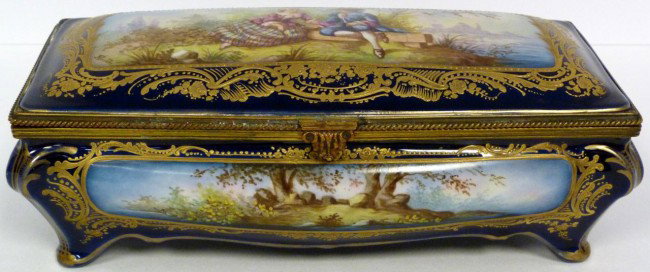 ANTIQUE SEVRES FRENCH PORCELAIN HINGED BOX SIGNED: Antique Sevres French porcelain hinged box. Has hand painted courting scene to cover and landscape scenes to front and back. Has gilded scroll design bordering on cobalt blue background. Hand painted 
