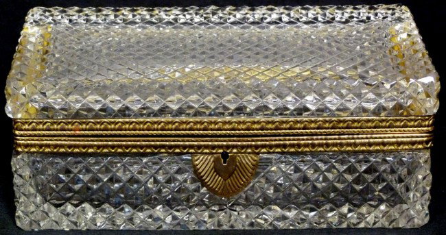 ANTIQUE FRENCH CUT GLASS AND BRONZE HINGED BOX: French rectangular cut glass box with bronze hinged frame. Glass has a diamond cut design to exterior. Bronze has a stylized floral design with locking mechanism to front. 19th century. Measures 3 1/2