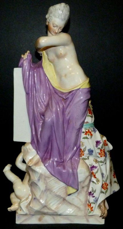 KPM GERMAN PORCELAIN NUDE & MONKEY GROUP FIGURE: Antique German porcelain figure depicting a monkey fully clothed and painting a picture of a nude female subject. On the floor is a cherub. A boot full of gold coins can also be seen. Blue scepter mar