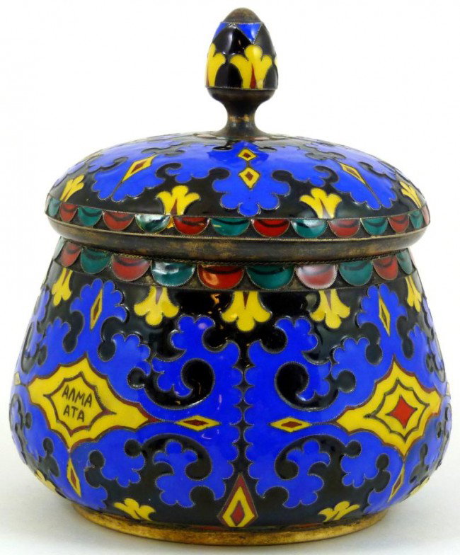 RUSSIAN SILVER & ENAMEL COVERED COVERED SUGAR BOWL: Russian silver and enamel covered sugar bowl. Soviet Hammer and sickle mark to bottom with 916 silver purity mark. Gold wash to silver. Blue, black, red, green and blue enamel throughout in a scrolled