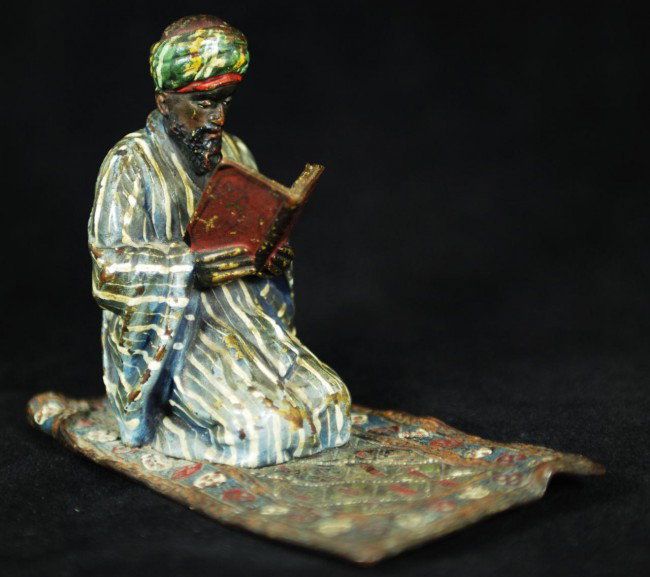 FRANZ BERGMAN COLD PAINTED BRONZE OF A BEDOUIN: Nam Greb (Franz Bergmann) (AUSTRIAN, 1838-1894) Austrian cold painted bronze figure of a Bedouin on carpet reading the Koran. Marked Geschutzt to bottom and numbered 3834 and 11. B in Urn impressed ma