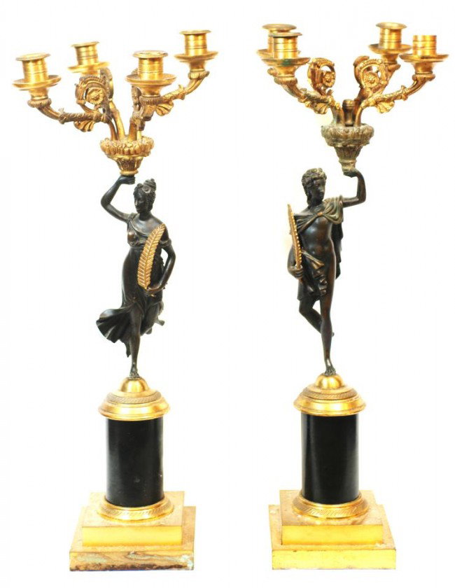 PAIR OF 19th C. BRONZE FIGURAL 4 ARM CANDELABRAS: Pair of antique bronze 4 arm candelabras. Each has a figural design depicting a man and woman holding wheat. Each is holding up a four arm candelabras with scrolled floral motifs. Gold and brown patin