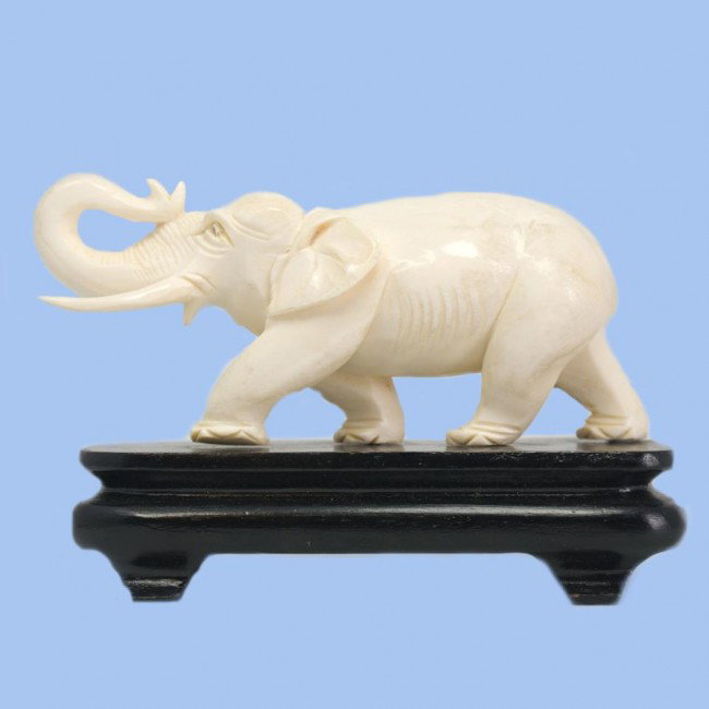 CHINESE IVORY HAND CARVED ELEPHANT FIGURE: Chinese ivory hand carved elephant figure with trunk and tusk up. Late 19th or early 20th century. Measures 2 3/8" height x 5 1/2" length + 1 1/4" base (6cm x 13.9cm + 3.1cm).