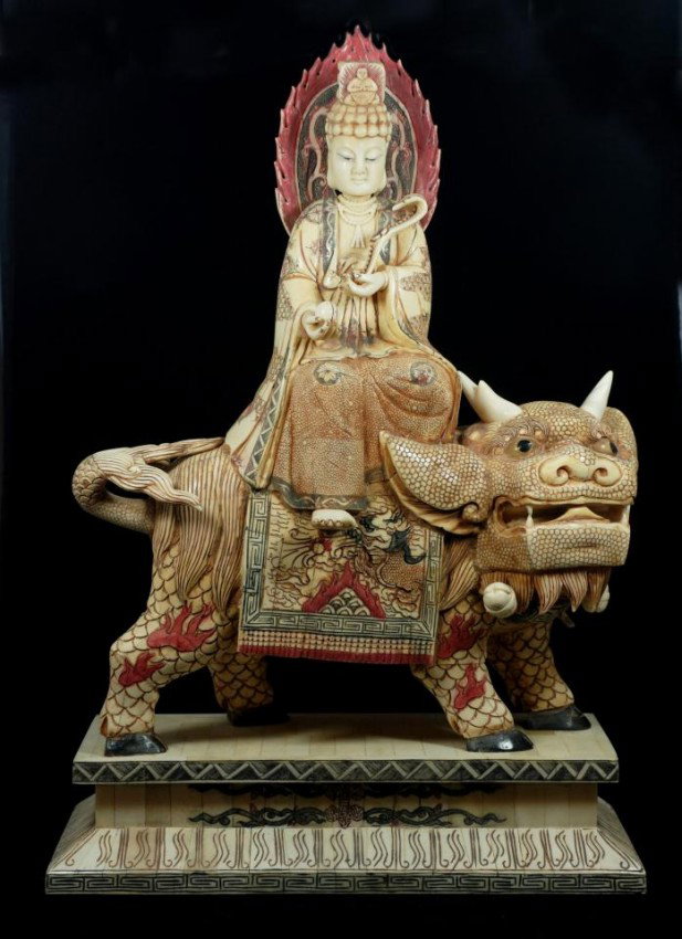 CHINESE CARVED BONE QUAN YIN ON FOO DOG FIGURE: Hand carved Chinese bone figure depicting a Quan Yin figure riding on the back of a kylin. Etched dragon scene to saddle. Quan Yin is depicted holding a Qing Dynasty Ruyi scepter in left hand and ball