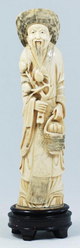 CHINESE CARVED IVORY FRUIT MERCHANT FIGURE: Chinese hand carved ivory old fruit merchant figure. Depicts a bearded old man in layered robe holding a basket of fruit and a peach branch. He also is wearing a hat. 19th century. Includes fitted woo