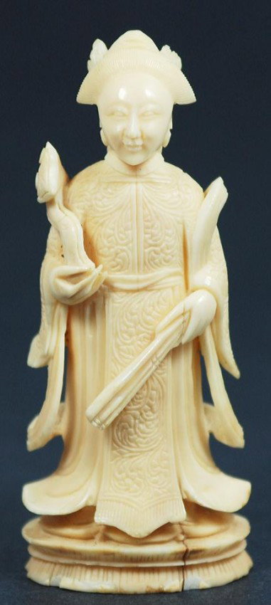 CHINESE CARVED IVORY QUAN YIN FIGURE: Chinese hand carved ivory Quanyin figure. She is wearing relief carved layered robe and holding a Ru yi scepter in one hand and a folding fan in the other symbolizing luck and fortune. 19th century. M