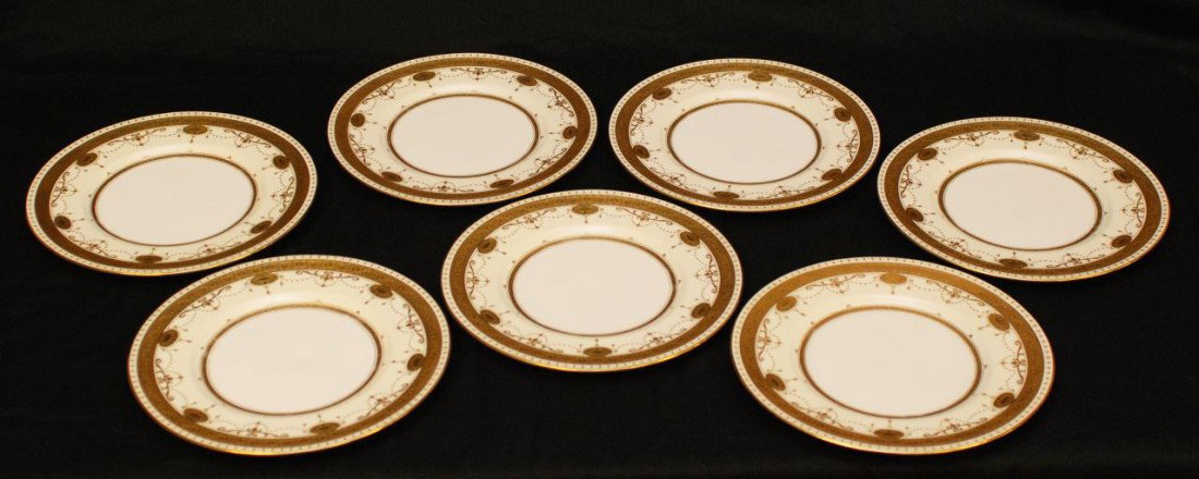 SET OF 7 MINTONS FOR TIFFANY & CO. GILT PLATES: 7 Mintons porcelain dinner plates. Each has a beautifully designed gilded rim over ivory background. Center is white. Impressed Mintons porcelain mark denotes the plates were in made circa 1924. Also 