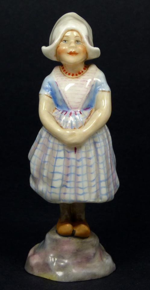 ROYAL WORCESTER FG DOUGHTY FIGURE HOLLAND: Royal Worcester World figure depicting girl with hands folded. Represents the country of Holland. #3074. Measures 5 1/2" height (13.9cm). Guaranteed original. Condition: Great. No apparent chips, crac