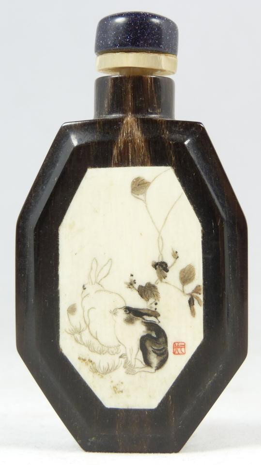 CHINESE INLAID IVORY & HORN SNUFF BOTTLE: Chinese hand carved horn snuff bottle with ivory inlaid plaque. Ivory plaque depicts rabbits and is signed to lower right. Reverse has a hand etched design depicting a Chinese Jue or ceremonial cup wi