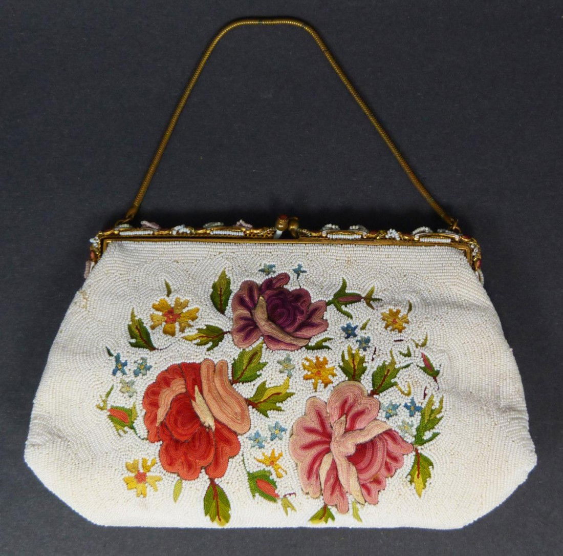 LADIES VINTAGE WHITE FLORAL BEADED HANDBAG: Vintage ladies microbead floral hand bag. Has gold hardware and white silk interior. Has enamel beaded design and rounded stones set to frame. Made in France. Measures 5 1/2" height x 8 5/8" width (13