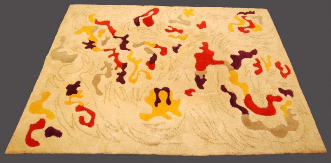 LARGE EDWARD FIELDS VIRGIN WOOL PILE RUG: Edward Fields virgin wool pile rug having abstract psychedelic shape design with reds and purples in off white surface. Has zig-zag design over white surface. Colored designs are cut lower than the wh