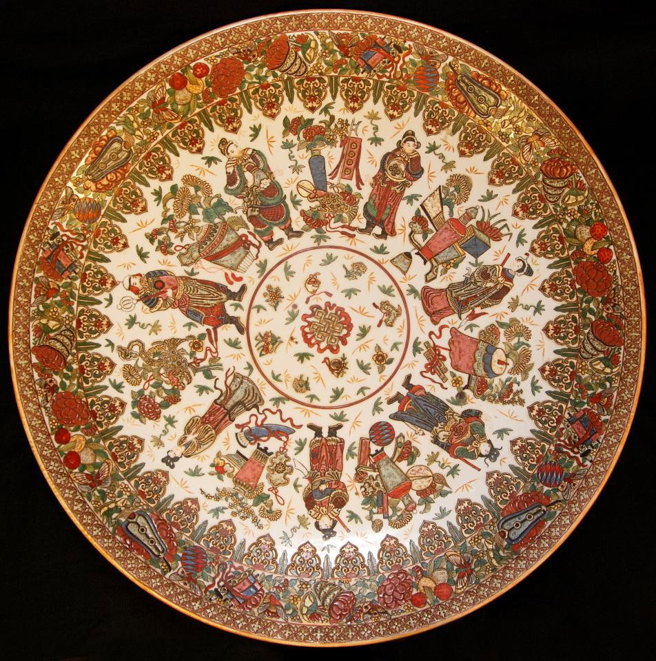 LARGE HAND PAINTED CHINESE PORCELAIN CHARGER: Stunning hand painted enameled charger. Depicts several figures, warriors, scholars and maidens. Incredible border design with scrolls, fans, butterflies, fruit and flowers. Reverse depicts flowers an