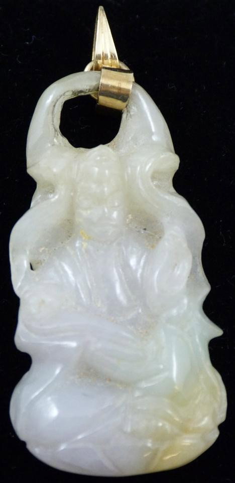 CHINESE CARVED JADE PENDANT w/ 14KT Y.G. BAIL: Carved jade pendant depicts man sitting on lotus blossom and holding Ruyi scepter. Measures 1 3/4" height x 1" width (4cm X 2cm).
