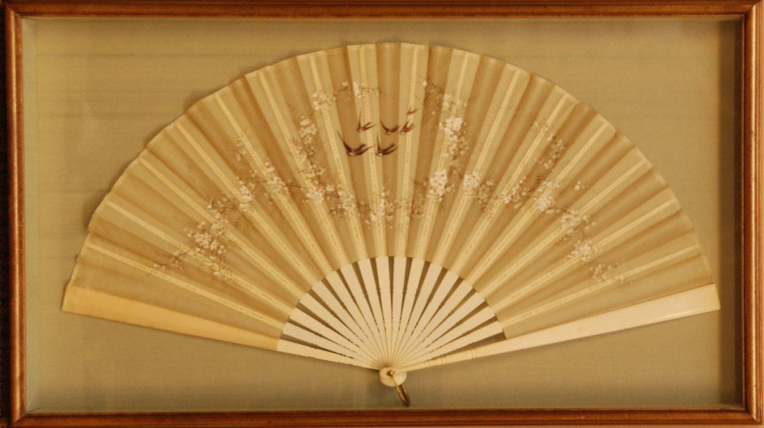 CHINESE DECORATED SILK & IVORY FAN IN FRAME: Chinese hand carved ivory and silk fan in shadow box. Has a beautiful hand painted floral bird design to fan. Fan measures 14" height x 26 1/2" width (35.5cm x 67.3cm).