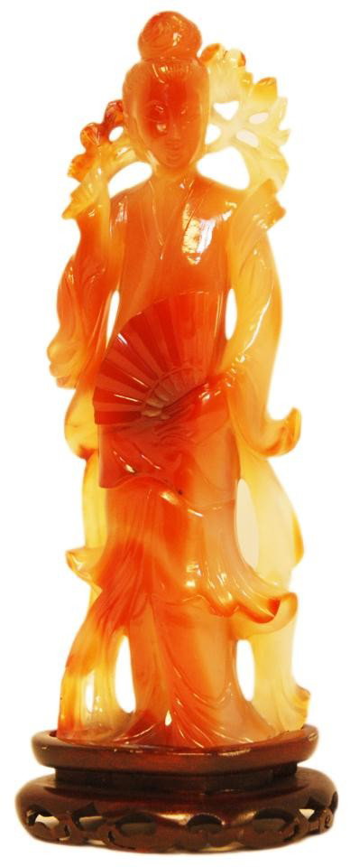 CHINESE CARVED CARNELIAN QUAN YIN FIGURE: Hand carved Chinese carved carnelian Quan Yin figure. Finely carved and fully reticulated. Includes fitted wooden base. Measures 7 5/8" height + 3/4" base height (19.3cm + 1.9cm).