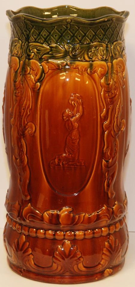 MAJOLICA GLAZED ART POTTERY UMBRELLA STAND: Antique Majolica glazed pottery umbrella stand. Measures 23" height x 10 1/2" diameter (58.4cm x 26.6cm).