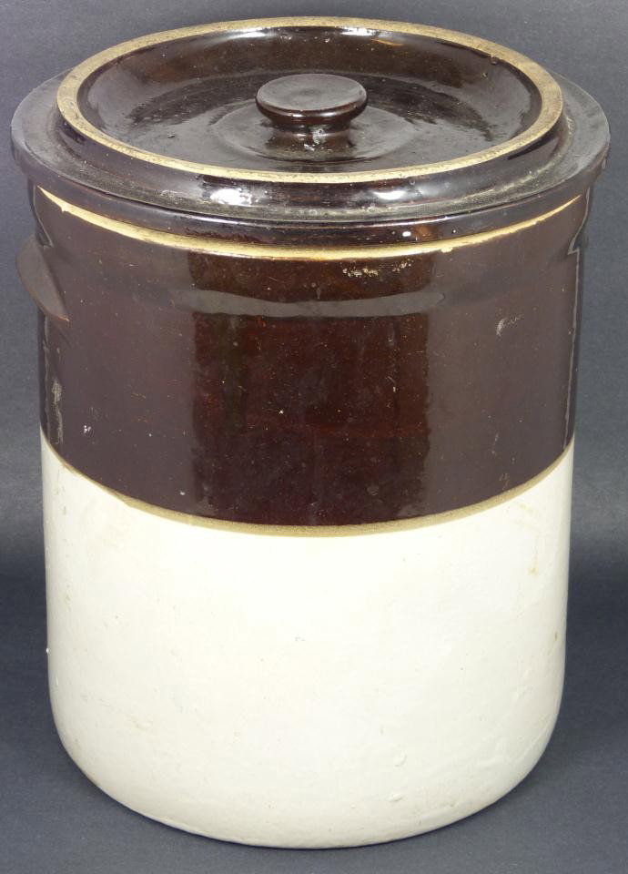 LARGE LIDDED STONEWARE CROCK POT: Large lidded stoneware crock pot with two tone glazed brown and white design to exterior. Has shaped handles to sides and handled cover. Dark brown glazed interior. Has a blue number 4 to front. 19th 