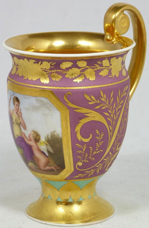 KONIGLICHE BERLIN KPM PORCELAIN PORTRAIT CUP: Beautiful antique Berlin "Königliche Porzellan Manufaktur" KPM hand painted portrait cup depicting a woman taking the bow & arrow from a cherub. Bordering has gilded scroll and flora with rust and tr