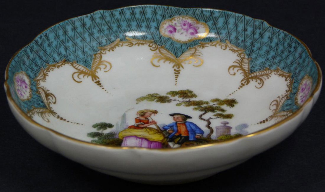 MEISSEN PORCELAIN BOWL w/ HAND PAINTED SCENE: Antique Meissen German porcelain bowl. Has hand painted scene depicting a courting couple to center. Rim has diamond pattern background with pink flowers. Has blue crossed swords mark to bottom. Measu
